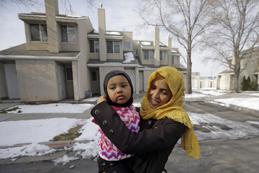 Somali refugee Nimo Hashi hugs her daughter Taslim at their home Tuesday, Jan. 31, 2017, in Salt Lake City. Hashi bought a new kitchen table and couches for her Salt Lake City apartment in joyful anticipation of reuniting Friday with her husband for the first time in nearly three years. But he won't be arriving as planned to see her and the 2-year-old daughter he's never met. He is among hundreds of people stuck in limbo after President Donald Trump's executive order temporarily banned refugees and nearly all travelers from seven Muslim-majority countries, including Somalia. (AP Photo/Rick Bowmer)