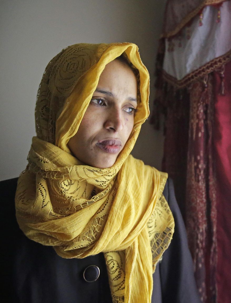 Somali refugee Nimo Hashi looks out the window at her home Tuesday, Jan. 31, 2017, in Salt Lake City. Hashi bought a new kitchen table and couches for her Salt Lake City apartment in joyful anticipation of reuniting Friday with her husband for the first time in nearly three years. But he won't be arriving as planned to see her and the 2-year-old daughter he's never met. He is among hundreds of people stuck in limbo after President Donald Trump's executive order temporarily banned refugees and nearly all travelers from seven Muslim-majority countries, including Somalia. (AP Photo/Rick Bowmer)