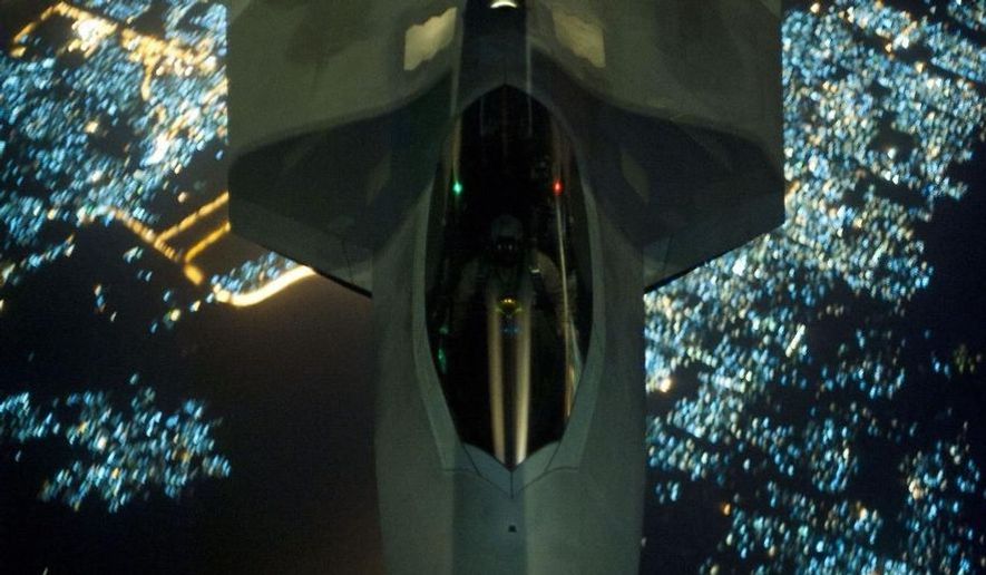 In this Friday, Sept. 26, 2014 photo, released by the U.S. Air Force, a U.S Air Force KC-10 Extender refuels an F-22 Raptor fighter aircraft prior to strike operations in Syria. The F-22s, making their combat debut, were part of a strike package that was engaging Islamic State group targets in Syria. (AP Photo/U.S. Air Force, Russ Scalf )