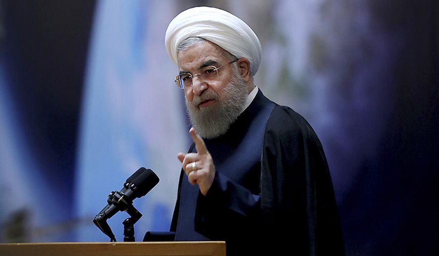 In this photo released by official website of the office of the Iranian Presidency, President Hassan Rouhani, speaks during a ceremony marking National Space Technology Day in Tehran, Iran, Wednesday, Feb. 1, 2017. President Hassan Rouhani has lashed out at the recent executive order by U.S. president Donald Trump to suspend immigration and visa processes for nationals from seven majority-Muslim countries, including Iran. (Iranian Presidency Office via AP)
