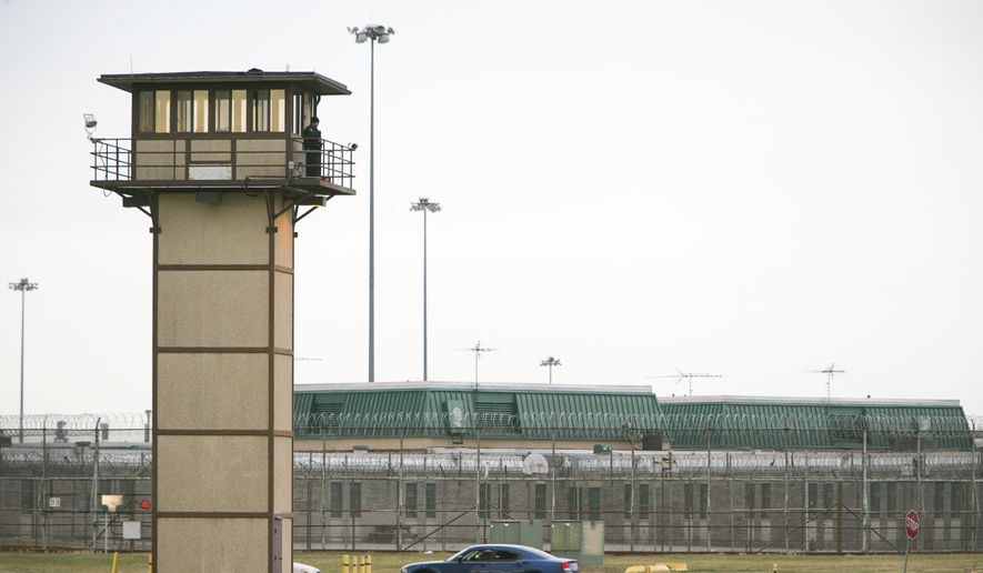 A prison guard stands at one of the towers at James T. Vaughn Correctional Center. All Delaware prisons went on lockdown Wednesday, Feb. 1, 2017, due to a hostage situation unfolding at the James T. Vaughn Correctional Center in Smyrna. Geoffrey Klopp, president of the Correctional Officers Association of Delaware, said he had been told by the Department of Correction commissioner that prison guards had been taken hostage. (Suchat Pederson/The Wilmington News-Journal via AP)