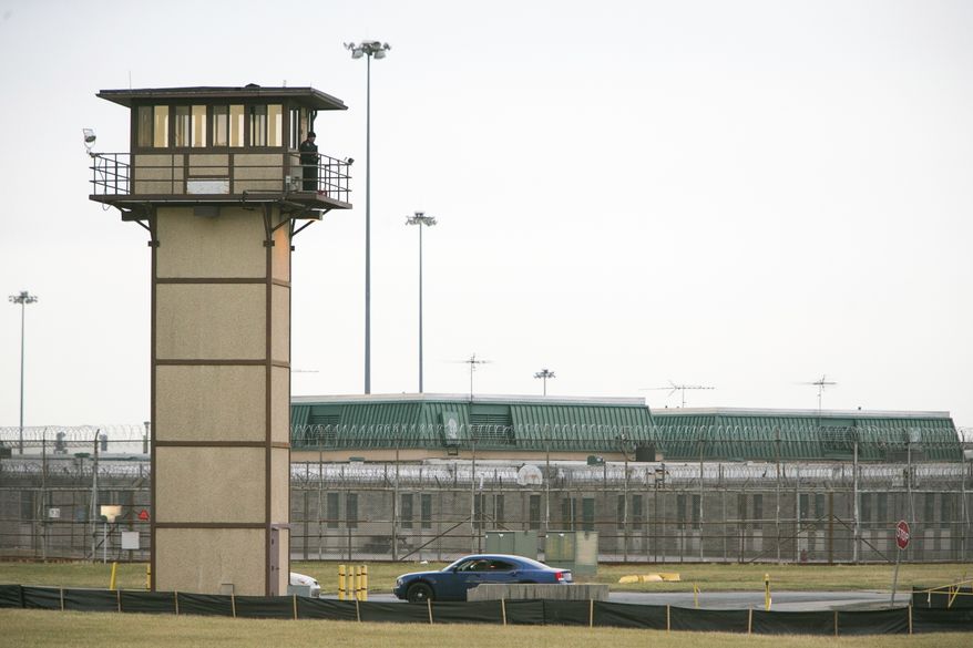 A prison guard stands at one of the towers at James T. Vaughn Correctional Center. All Delaware prisons went on lockdown Wednesday, Feb. 1, 2017, due to a hostage situation unfolding at the James T. Vaughn Correctional Center in Smyrna. Geoffrey Klopp, president of the Correctional Officers Association of Delaware, said he had been told by the Department of Correction commissioner that prison guards had been taken hostage. (Suchat Pederson/The Wilmington News-Journal via AP)