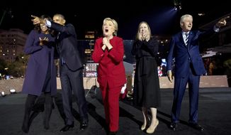 In this Monday, Nov. 7, 2016, file photo, Democratic presidential candidate Hillary Clinton, center, is joined onstage by first lady Michelle Obama, left, President Barack Obama, second from left, Chelsea Clinton, second from right, and former President Bill Clinton, right, after speaking at a rally at Independence Mall in Philadelphia. (AP Photo/Andrew Harnik, File)