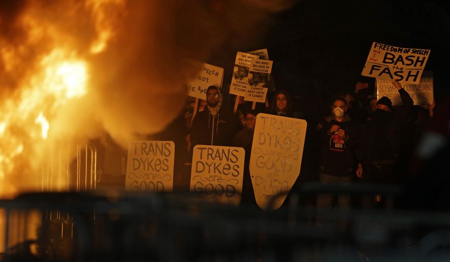 Protestors watch a bonefire on Sproul Plaza during a rally against the scheduled speaking appearance by Breitbart News editor Milo Yiannopoulos on the University of California at Berkeley campus on Wednesday, Feb. 1, 2017, in Berkeley, Calif. The event was canceled out of safety concerns after protesters hurled smoke bombs, broke windows and started a bonfire. (AP Photo/Ben Margot)