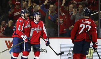 Washington Capitals right wing T.J. Oshie, center, celebrates his first period goal with teammate Alex Ovechkin (8) of Russia during the first period of an NHL hockey game in Washington, Wednesday, Feb. 1, 2017. (AP Photo/Manuel Balce Ceneta)