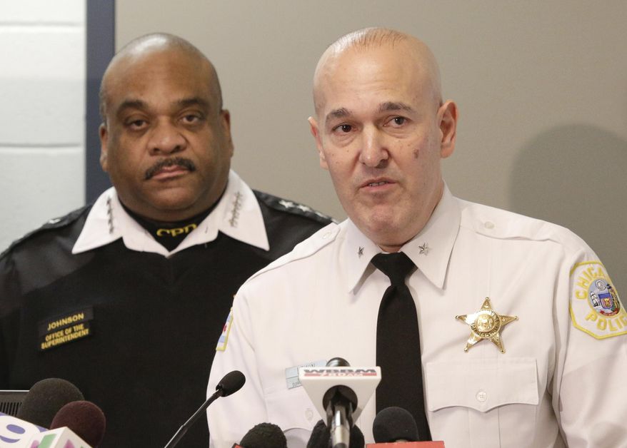 Jonathan Lewin, Deputy Chief Technology and Records Group with the Chicago Police Department accompanied by Police Superintendent Eddie Johnson speaks at a news conference Wednesday, Feb. 1, 2017, in Chicago. The Police Department unveiled new high-tech crime-fighting strategies as the city deals with increases in homicides and gang violence. Supt. Johnson also released crime figures that show there were 51 homicides during January, or a 1 percent increase over last year. (AP Photo/Teresa Crawford)