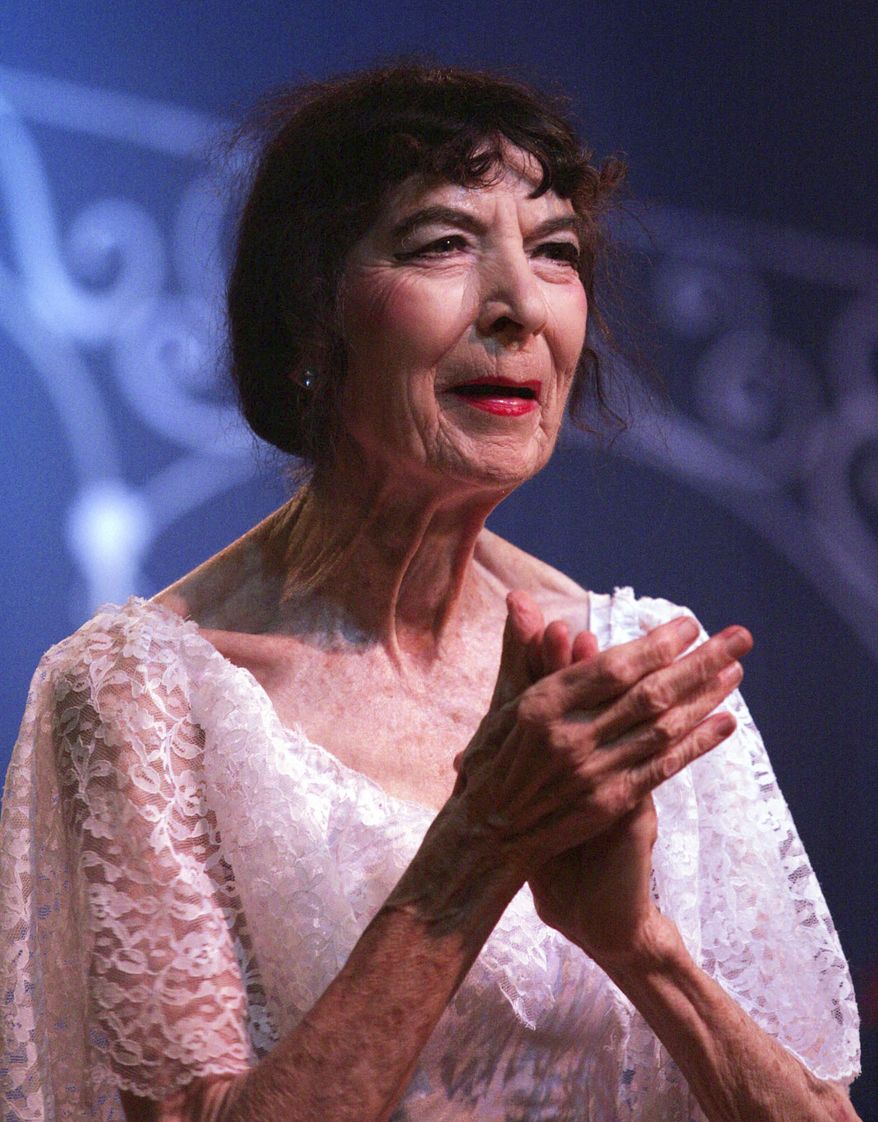 FILE - In this Oct. 1, 2005 file photo, Marta Becket acknowledges a standing ovation after the inaugural performance of "Masquerade" at the Amargosa Opera House in Death Valley Junction, Calif. Becket, a performance artist who spent decades presenting on one-woman shows at a remote Mojave Desert community hall that she transformed with paint brush and passion and made famous as the Amargosa Opera House, died Monday, Jan. 30, 2017, at her home in Death Valley Junction, Calif. She was 92. (Sam Morris/The Las Vegas Sun via AP, File)