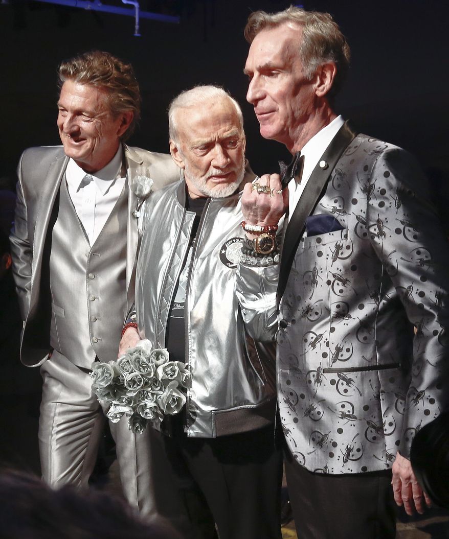 Fashion designer Nick Graham, left, poses with his guest models, astronaut Buzz Aldrin, center, and Bill Nye, star of TV's "Science Guy," after unveiling his Mars-themed collection during men's Fashion Week, Tuesday, Jan. 31, 2017, in New York. (AP Photo/Bebeto Matthews)