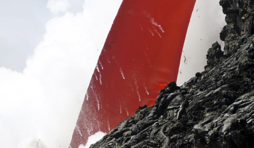 This Jan. 28, 2017 photo provided by the U.S. Geological Survey shows a closeup view of a lava stream pouring out of a lava tube on the sea cliff at the Kamokuna ocean entry at the Hawaii Volcanoes National Park on the Big Island of Hawaii. A dramatic "firehose" stream of lava is shooting out of a sea cliff on Hawaii Island, splashing into the Pacific Ocean below and exploding upon impact. A USGS geologist with the Hawaii Volcano Observatory said Wednesday, Feb. 1, 2017 that one of the biggest concerns is a large "hot crack" above the lava tube, running parallel to the sea cliff and makes the land susceptible to collapse. (U.S. Geological Survey via AP)