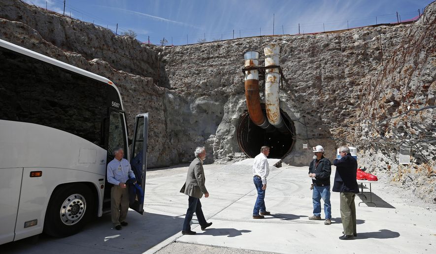 FILE - In this April 9, 2015 file photo, congressmen arrive at the south portal of Yucca Mountain during a congressional tour near Mercury, Nev. Facing a new presidential administration and a Republican-controlled Congress without now retired Sen. Harry Reid, Nevada officials are gearing up to resume a 30-year fight to stop a federal proposal to bury the nation's nuclear waste about 100 miles northwest of Las Vegas, though some local officials who live near the site aren't on the same page. (AP Photo/John Locher,File)