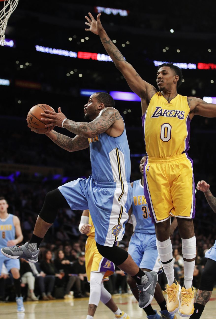 Denver Nuggets' Jameer Nelson, left, goes up for a basket under defense by Los Angeles Lakers' Nick Young during the first half of an NBA basketball game, Tuesday, Jan. 31, 2017, in Los Angeles. (AP Photo/Jae C. Hong)