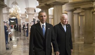 President Barack Obama and Vice President Joe Biden walk through the Crypt of the Capitol in Washington, Friday, Jan. 20, 2017, for Donald Trump&#x27;s inauguration ceremony. (AP Photo/J. Scott Applewhite, Pool)