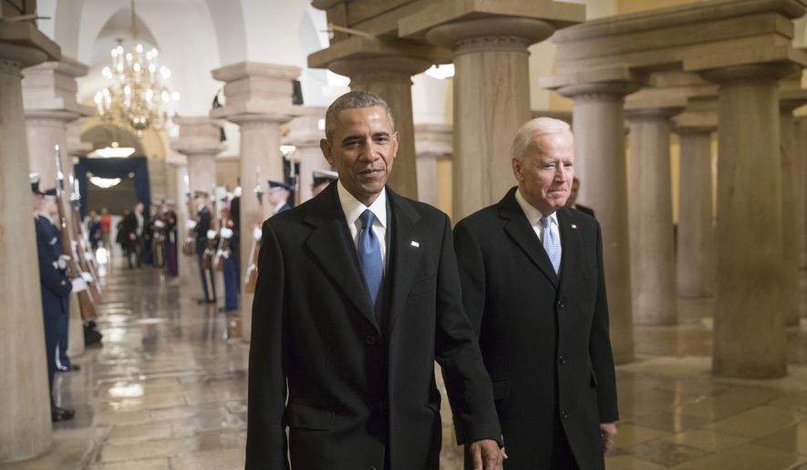 President Barack Obama and Vice President Joe Biden walk through the Crypt of the Capitol in Washington, Friday, Jan. 20, 2017, for Donald Trump&#39;s inauguration ceremony. (AP Photo/J. Scott Applewhite, Pool)