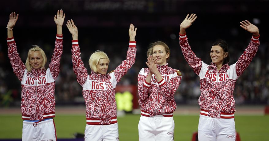 FILE - In this Aug. 11, 2012 file photo Russia's Yulia Gushchina, Antonina Krivoshapka, Tatyana Firova and Natalya Antyukh react before receiving their silver medals for the women's 4x400-meter during the athletics in the Olympic Stadium at the 2012 Summer Olympics, London. The IOC said Wednesday, Feb. 1, 2017 it has stripped Russia of an Olympic silver medal from the women's 4x400-meter relay at the 2012 London Games for doping. The IOC says Antonina Krivoshapka tested positive for the anabolic steroid turinabol in reanalysis of samples from the 2008 and 2012 Olympics. (AP Photo/Matt Slocum, file)