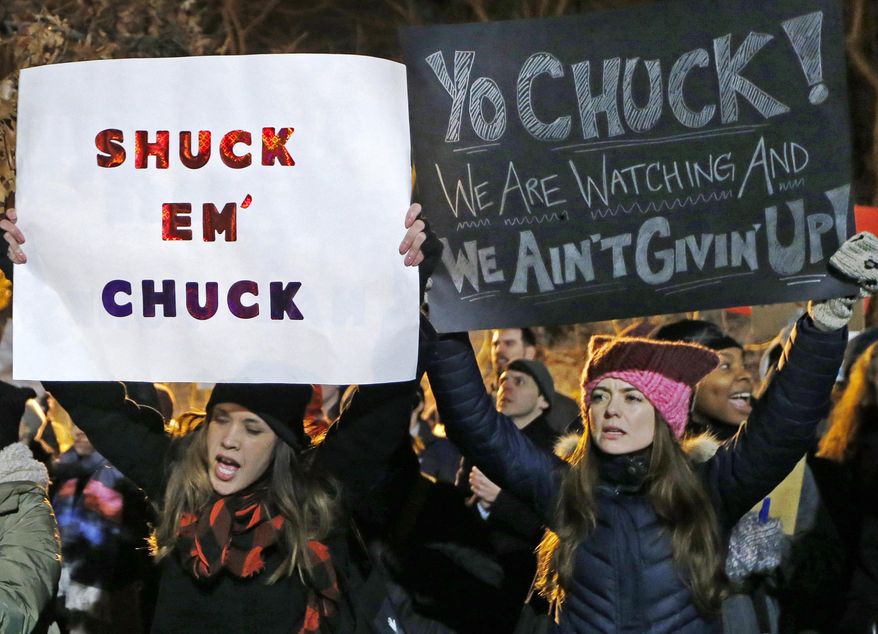 Women demonstrate across the street from the New York city residence of Senate Minority leader Chuck Schumer during the second in a series of "Resist Trump Tuesdays," on Tuesday, Jan. 31, 2017, in New York. Liberals are vowing to put pressure on Schumer to mount a vigorous opposition to the agenda of President Donald Trump. (AP Photo/Kathy Willens)