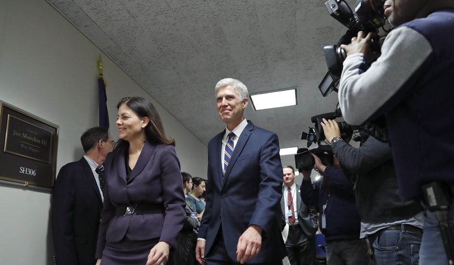 Supreme Court Justice nominee Neil Gorsuch, center arrives for a meeting with Sen. Joe Manchin, D-W.Va., on Capitol Hill, Wednesday, Feb. 1, 2017 in Washington. Former Sen. Kelly Ayotte from New Hampshire walks with Gorsuch at left. (AP Photo/Alex Brandon)