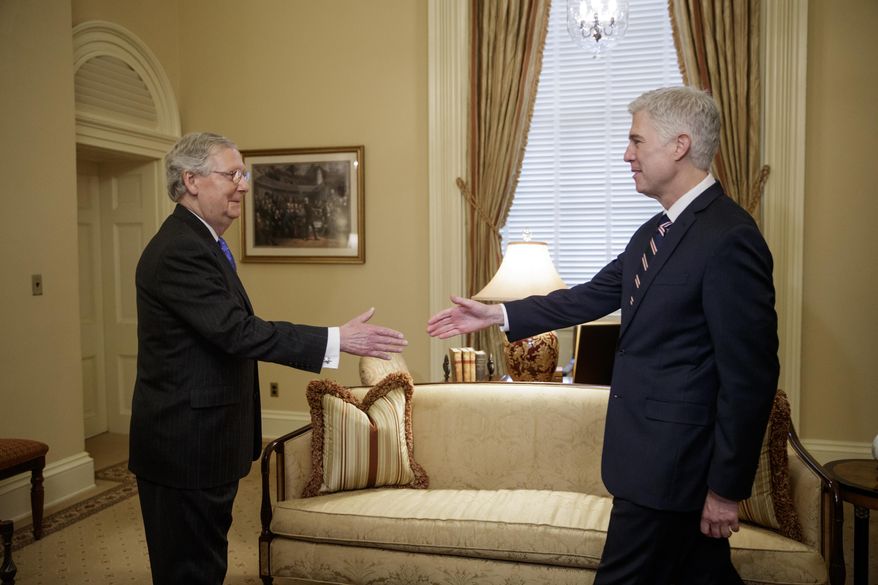 Supreme Court Justice nominee Neil Gorsuch is greeted by Senate Majority Leader Mitch McConnell of Ky. on Capitol Hill in Washington, Wednesday, Feb. 1, 2017. Last year, Senate Republicans, led by McConnell, blocked a confirmation hearing for Judge Merrick Garland, President Barack Obama's pick for the vacancy left by the death of Justice Antonin Scalia who died in February 2016. (AP Photo/J. Scott Applewhite)