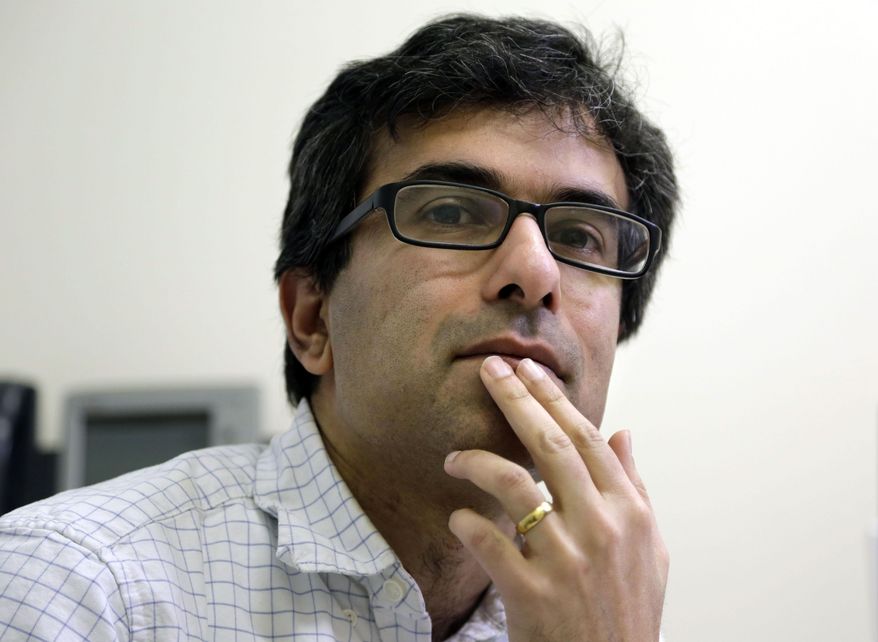 Harvard medical researcher Soumya Raychaudhuri, of Brookline, Mass., pauses during an interview at Brigham and Women's Hospital in Boston on Tuesday, Jan. 31, 2017. Raychaudhuri awaits the fate of a new hire, Samira Asgari, an Iranian national who was not allowed to board a flight in Switzerland to Boston due to the travel ban issued by President Donald Trump. (AP Photo/Steven Senne)