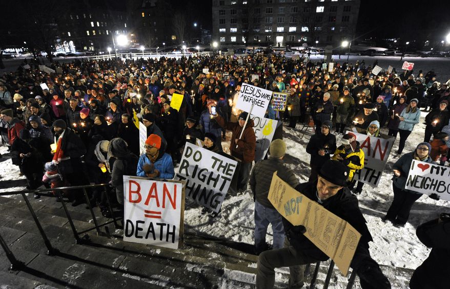 A crowd gathers on the State House lawn in Montpelier, Vt., Wednesday, Feb. 1, 2017, for a solidarity candlelight vigil in response to President Donald Trump's recent travel ban on refugees and citizens of certain majority-Muslim countries. (Jeb Wallace-Brodeur/The Times Argus via AP)