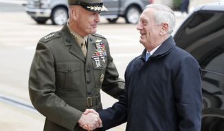 FILE - In this Jan. 21, 2107 file photo, Joint Chiefs Chairman Gen. Joseph Dunford greets Defense Secretary Jimn Mattis at the Pentagon. By visiting Japan and South Korea on his first official overseas trip, Mattis is seeking to reinforce key alliances after President Donald Trump’s campaign-trail complaints that defense treaties disadvantaged the United States.(AP Photo/Alex Brandon, File)
