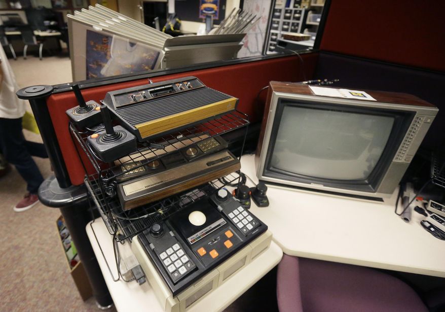In this May 20, 2016, vintage gaming consoles are displayed at the Duderstadt Center at the University of Michigan in Ann Arbor, Mich. The university's archive features over 7,000 titles - everything from time-honored favorites such as "Pac-Man" and "Frogger" to newer fare, including "Call of Duty" and "Halo" - on dozens of gaming systems. And unlike some other video game archives out there, students and members of the public alike are permitted to visit and play any game available, whether for research or just to relax. (AP Photo/Carlos Osorio)