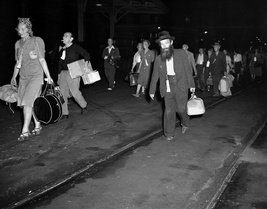 FILE - In this Aug. 4, 1944 file photo, civilian refugees from occupied Europe arrive at Hoboken, N.J., during World War II. The refugees, who will be given sanctuary for the duration of the war, will go to Fort Ontario, Oswego, N.Y., where an emergency relief shelter was established. Jewish refugees from Europe were blocked during and after World War II _ first because of fears that they might be German sympathizers, then because of fears that they were Communists. (AP Photo/File)