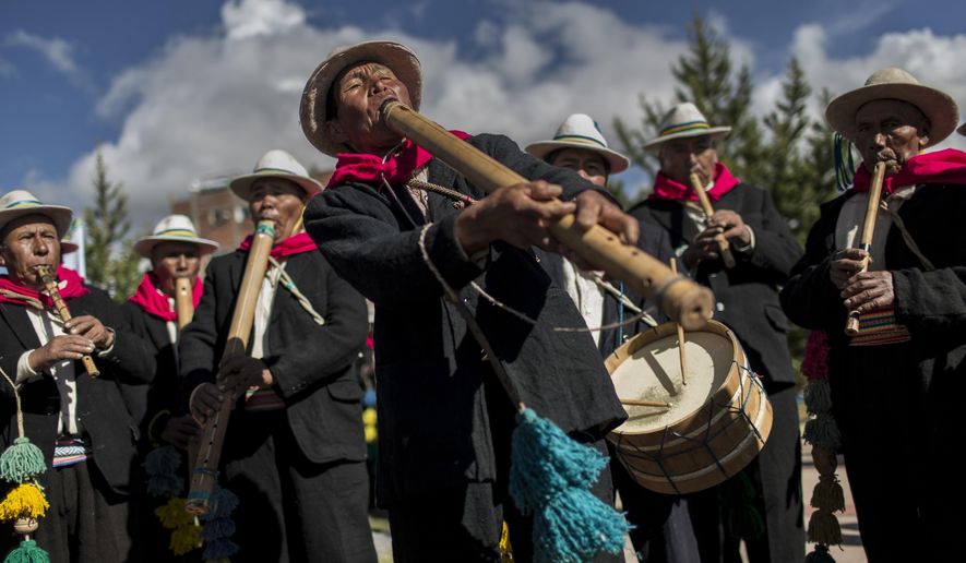 In this Jan. 29, 2017 photo, musicians perform for dancers on the shores of Lake Titicaca, as they practice before their presentation for the Virgin of Candelaria celebrations in Puno, Peru. Dancers in colorful masks and elaborate costume celebrate the Virgin of Candelaria, patron saint of communities along the shore of Lake Titicaca, in what's considered the largest Catholic festival in the Andes. (AP Photo/Rodrigo Abd)