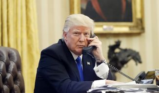 In this Jan. 28, 2017, file photo, U.S. President Donald Trump speaks on the phone with Prime Minister of Australia Malcolm Turnbull in the Oval Office of the White House in Washington. (AP Photo/Alex Brandon, File)