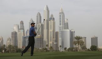 Tiger Woods follows his ball on the 13th hole during the 1st round of the Dubai Desert Classic golf tournament in Dubai, United Arab Emirates, Thursday, Feb. 2, 2017. (AP Photo/Kamran Jebreili)