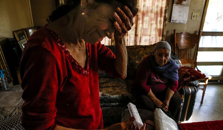 ADVANCE FOR SUNDAY, FEB. 5, 2017 - In this Friday, Dec. 16, 2016 photo, Nina Newell, left, a home health worker, looks through medication for her mother, Maria Mata, right, at her mother&#x27;s home in Brownsville, Texas. Along Texas&#x27; southern border, home health care accounts for more than one in ten total jobs, making the Rio Grande Valley the nation&#x27;s capital of home health care. ( Michael Ciaglo /Houston Chronicle via AP)