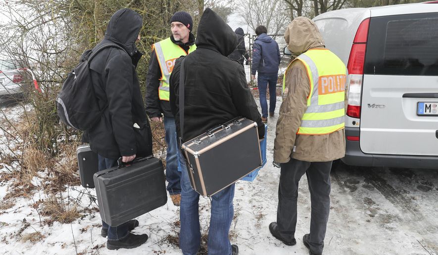 Police officers and forensics walk towards the private premises where the bodies of six teenagers were found near Arnstein, Germany, Monday, Jan. 30, 2017. German prosecutors say they have ordered that autopsies be conducted on the bodies. (Daniel Karmann/dpa via AP)