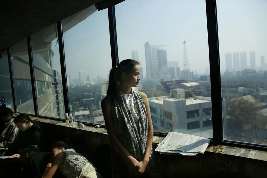 In this  Jan 30, 2017 photo, Anjali Lama, a transgender model from Nepal, looks out of a window of a hotel during a trial event for Lakme Fashion week in Mumbai, India. Growing up as the fifth son in a poor farming family in rural Nepal the dream to be a fashion model came late in life. First came a long, painful struggle to accept that he felt deeply female. It was a chance encounter with a group of transgender women that turned Lama's life around by putting her in touch with the Blue Diamond Society, an advocacy group for Nepal's LGBT community. In 2005 she came out to her friends and family as a transgender woman. (AP Photo/Rafiq Maqbool)