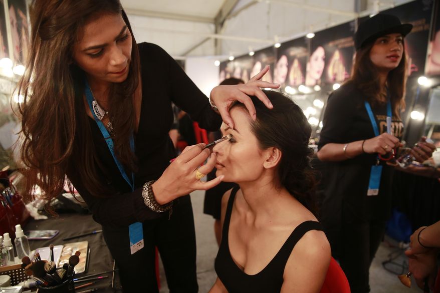 In this Feb. 1, 2017 photo, a makeup artist applies eye-shadow on Anjali Lama, a transgender model from Nepal, during Lakme Fashion week in Mumbai, India. Growing up as the fifth son in a poor farming family in rural Nepal the dream to be a fashion model came late in life. First came a long, painful struggle to accept that he felt deeply female. It was a chance encounter with a group of transgender women that turned Lama&#x27;s life around by putting her in touch with the Blue Diamond Society, an advocacy group for Nepal&#x27;s LGBT community. In 2005 she came out to her friends and family as a transgender woman. (AP Photo/Rafiq Maqbool)