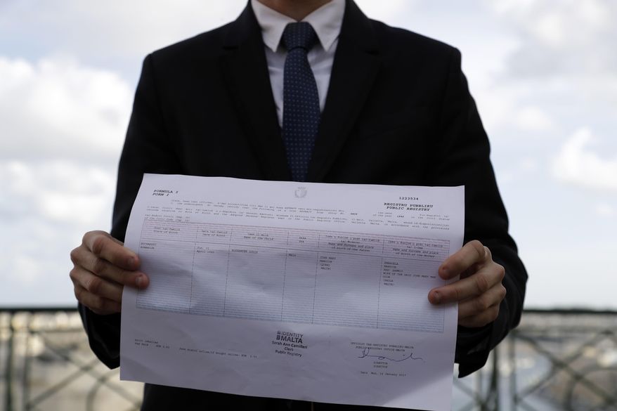 Politician Alex Mangion shows an official document where his chosen gender is registered, during an interview with the Associated Press, in Valletta, Wednesday, Feb. 1, 2017. Lithe and dapper in a navy-blue suit as he gazed at this capital city's storied Grand Harbor, Alex Mangion proudly described becoming Malta's first transgender politician, winning a local office on the conservative Nationalists' ticket in a country that until just a few years ago had been a last bastion in Western Europe of social norms largely dictated by the Catholic church. (AP Photo/Gregorio Borgia)