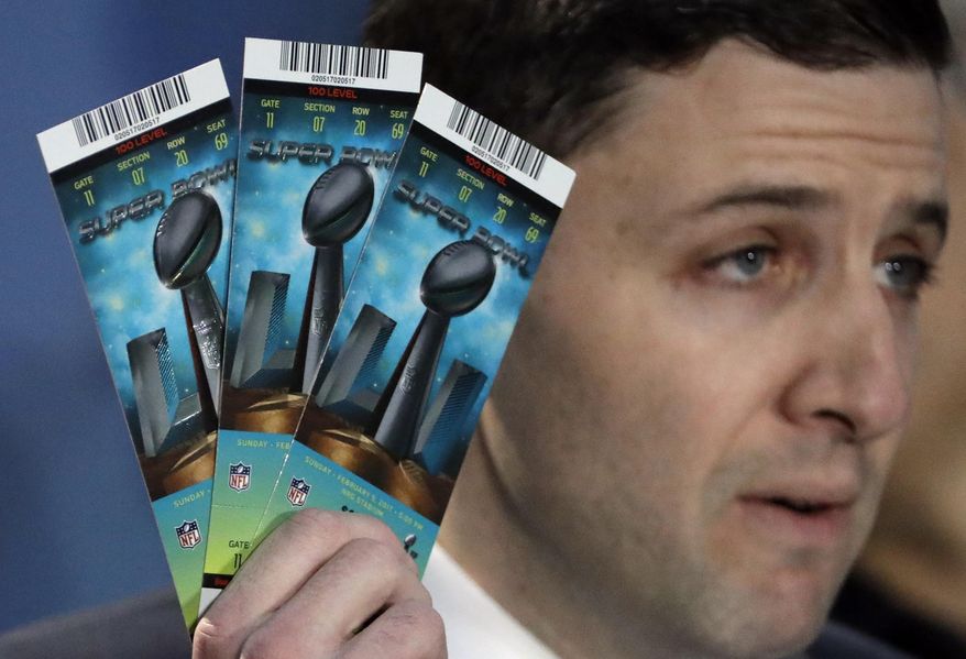 NFL Senior Counsel of Legal Affairs Michael Buchwald holds up Super Bowl 51 tickets as he explains the anti-counterfeit features of legitimate tickets during a news conference for the NFL Super Bowl 51 football game Thursday, Feb. 2, 2017, in Houston. (AP Photo/David J. Phillip)