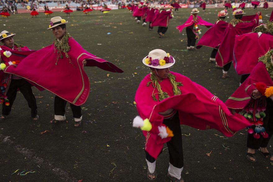 In this Jan. 29, 2017 photo, dancers perform during Virgin of Candelaria celebrations in Puno, Peru. Some dances gesture toward everyday village activities such as grazing llamas or shearing animals. Others depict the Spanish conquest or the conscription of villagers as soldiers. (AP Photo/Rodrigo Abd)