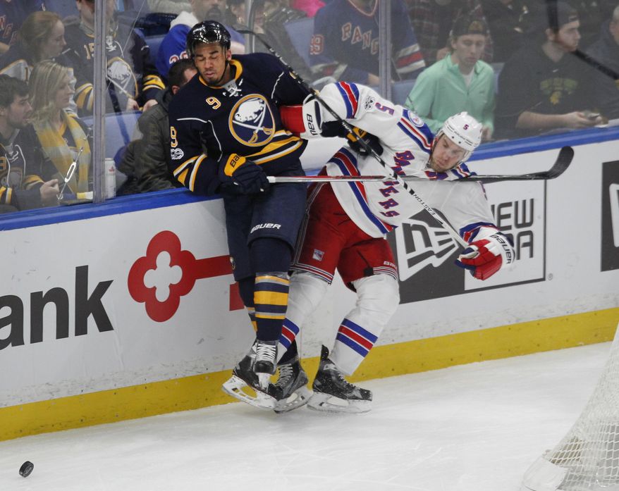 Buffalo Sabres forward Evander Kane (9) and New York Rangers defenseman Dan Girardi (5) battle for the puck during the second period of an NHL hockey game, Thursday Feb. 2, 2017, in Buffalo, N.Y. (AP Photo/Jeffrey T. Barnes)