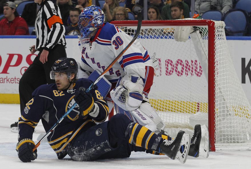 Buffalo Sabres forward Marcus Foligno (82) is knocked down in front of New York Rangers goalie Henril Lindqvist (30) during the first period of an NHL hockey game, Thursday Feb. 2, 2017, in Buffalo, N.Y. (AP Photo/Jeffrey T. Barnes)