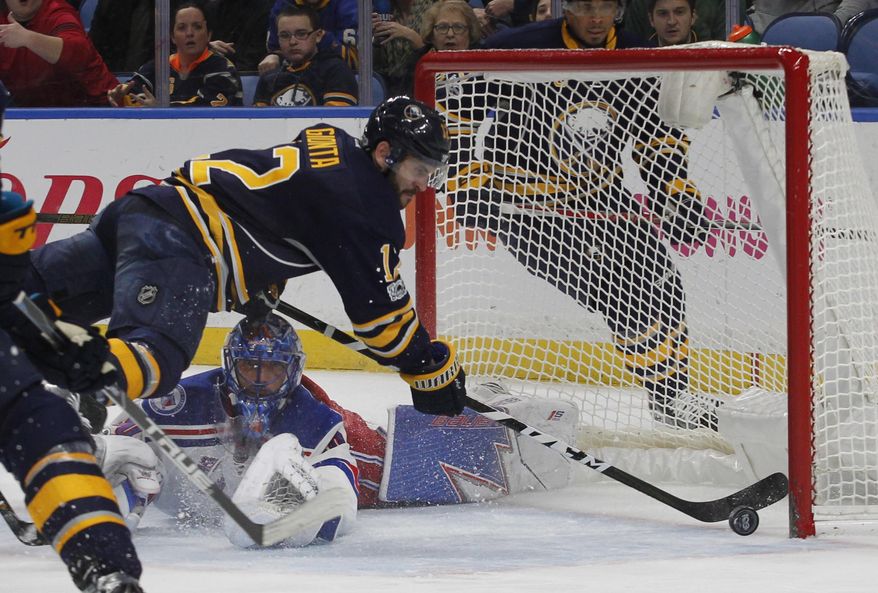 Buffalo Sabres forward Brian Gionta (12) attempts to put the puck past New York Rangers goalie Henrik Lundqvist (30) during the first period of an NHL hockey game, Thursday Feb. 2, 2017, in Buffalo, N.Y. (AP Photo/Jeffrey T. Barnes)