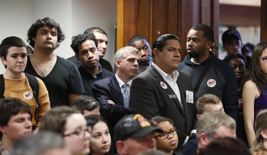 An overflow crowd gathers to hear l discussion about House Bill 37 during a meeting of the House Committee on Higher Education Wednesday, Feb. 1, 2017, in Atlanta. Under the bill private colleges that don't cooperate with federal immigration authorities would lose state funding for scholarships and research. (AP Photo/John Bazemore)