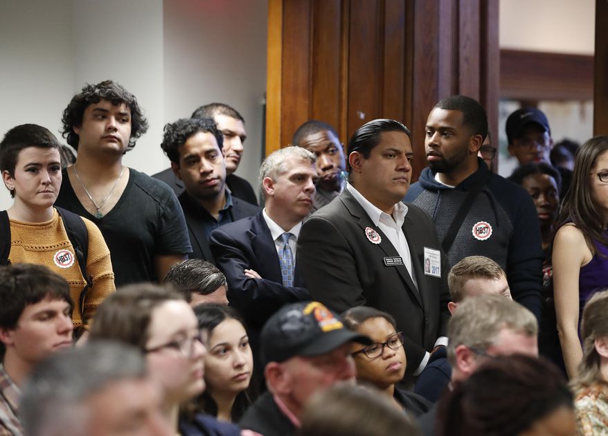 An overflow crowd gathers to hear l discussion about House Bill 37 during a meeting of the House Committee on Higher Education Wednesday, Feb. 1, 2017, in Atlanta. Under the bill private colleges that don't cooperate with federal immigration authorities would lose state funding for scholarships and research. (AP Photo/John Bazemore)