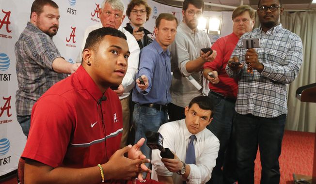 Highly touted quarterback recruit Tua Tagovailoa speaks to the media during a news conference announcing the recruiting class for the University of Alabama in Tuscaloosa, Ala., Wednesday, Feb. 1, 2017. Tagovailoa is one of the players who took advantage of early enrollment. (Gary Cosby Jr./The Tuscaloosa News via AP)