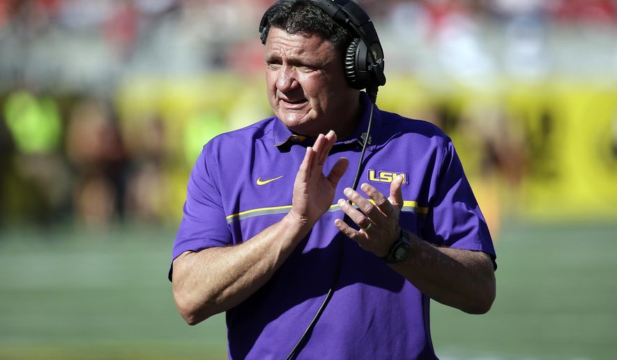 FILE - In this Dec. 31, 2016, file photo, LSU coach Ed Orgeron encourages players during the second half of the Citrus Bowl NCAA football game against Louisville in Orlando, Fla. Orgeron's maiden signing class with the Tigers reflected his reputation as a strong recruiter — even if the Louisiana native acknowledged he wasn't pleased by some near misses in his home state. (AP Photo/John Raoux, File)
