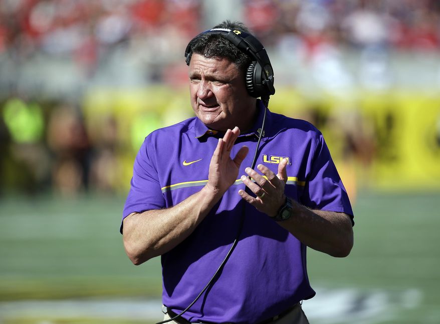 FILE - In this Dec. 31, 2016, file photo, LSU coach Ed Orgeron encourages players during the second half of the Citrus Bowl NCAA football game against Louisville in Orlando, Fla. Orgeron's maiden signing class with the Tigers reflected his reputation as a strong recruiter — even if the Louisiana native acknowledged he wasn't pleased by some near misses in his home state. (AP Photo/John Raoux, File)