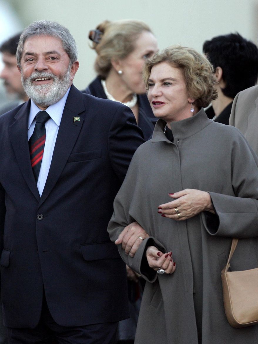FILE - In this Sept. 14, 2007 file photo, Brazil's President Luiz Ignacio Lula da Silva, left, walks with his wife Marisa Leticia upon arrival to a military airbase in Torrejon de Ardoz, Spain. Doctors and the former president said Thursday, Feb. 2, 2017 Brazil's former first lady no longer has brain function and they are preparing to donate her organs. The 66-year-old former first lady had been hospitalized in Sao Paulo since Jan. 24 after suffering a stroke. (AP Photo/Paul White, File)