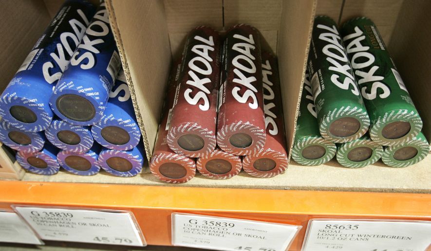 FILE - In this Oct. 23, 2008, file photo, Skoal smokeless tobacco is seen on display at a Costco store in Mountain View, Calif. It was announced by the U.S. Food and Drug Administration on Jan. 31, 2017, that some varieties of Skoal, Copenhagen, Cope and Husky brand smokeless tobacco are being voluntarily recalled by U.S. Smokeless Tobacco Company’s amid complaints of metal objects, some of them sharp, being spotted in cans. (AP Photo/Paul Sakuma, File)