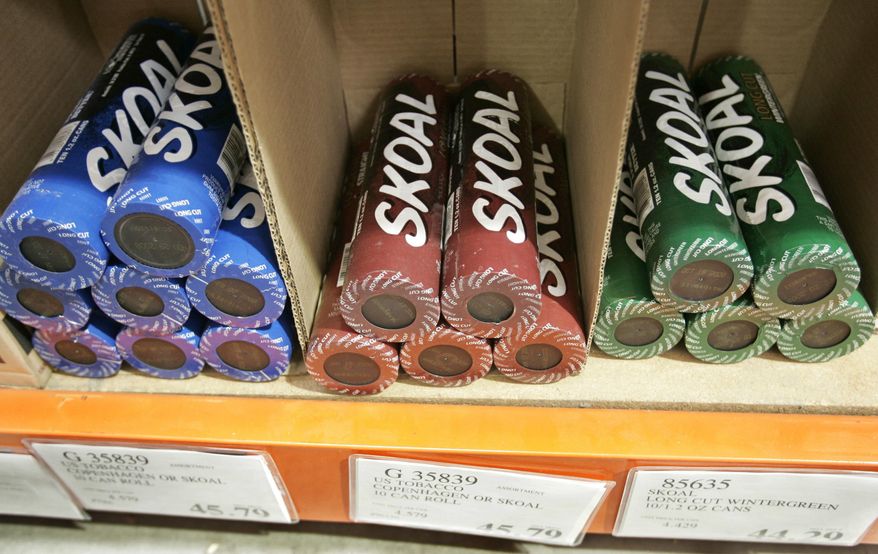 FILE - In this Oct. 23, 2008, file photo, Skoal smokeless tobacco is seen on display at a Costco store in Mountain View, Calif. It was announced by the U.S. Food and Drug Administration on Jan. 31, 2017, that some varieties of Skoal, Copenhagen, Cope and Husky brand smokeless tobacco are being voluntarily recalled by U.S. Smokeless Tobacco Company’s amid complaints of metal objects, some of them sharp, being spotted in cans. (AP Photo/Paul Sakuma, File)