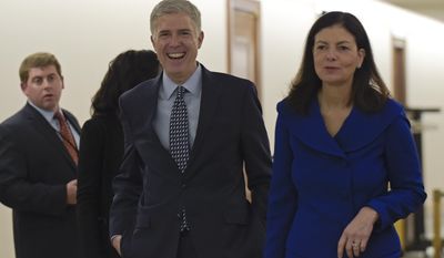 Supreme Court nominee Judge Neil Gorsuch, center, arrives with former New Hampshire Sen. Kelly Ayotte on Capitol Hill in Washington, Thursday, Feb. 2, 2017, for a meeting with Sen. Bob Corker, R-Tenn.  (AP Photo/Susan Walsh)