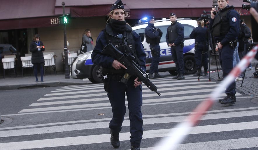 Police officers take position outside the Louvre museum in Paris,Friday, Feb. 3, 2017. Paris police say a soldier has opened fire outside the Louvre Museum after he was attacked by someone, and the area is being evacuated. (AP Photo/Thibault Camus)