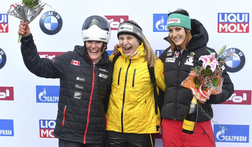 Germany's winner Tina Hermann, center, Canada's second placed Mirela Rahneva, left, and Austria's third placed Janine Flock pose for media after the women's Skeleton World Cup race in Igls, near Innsbruck, Austria, Friday, Feb. 3, 2017. (AP Photo/Kerstin Joensson)